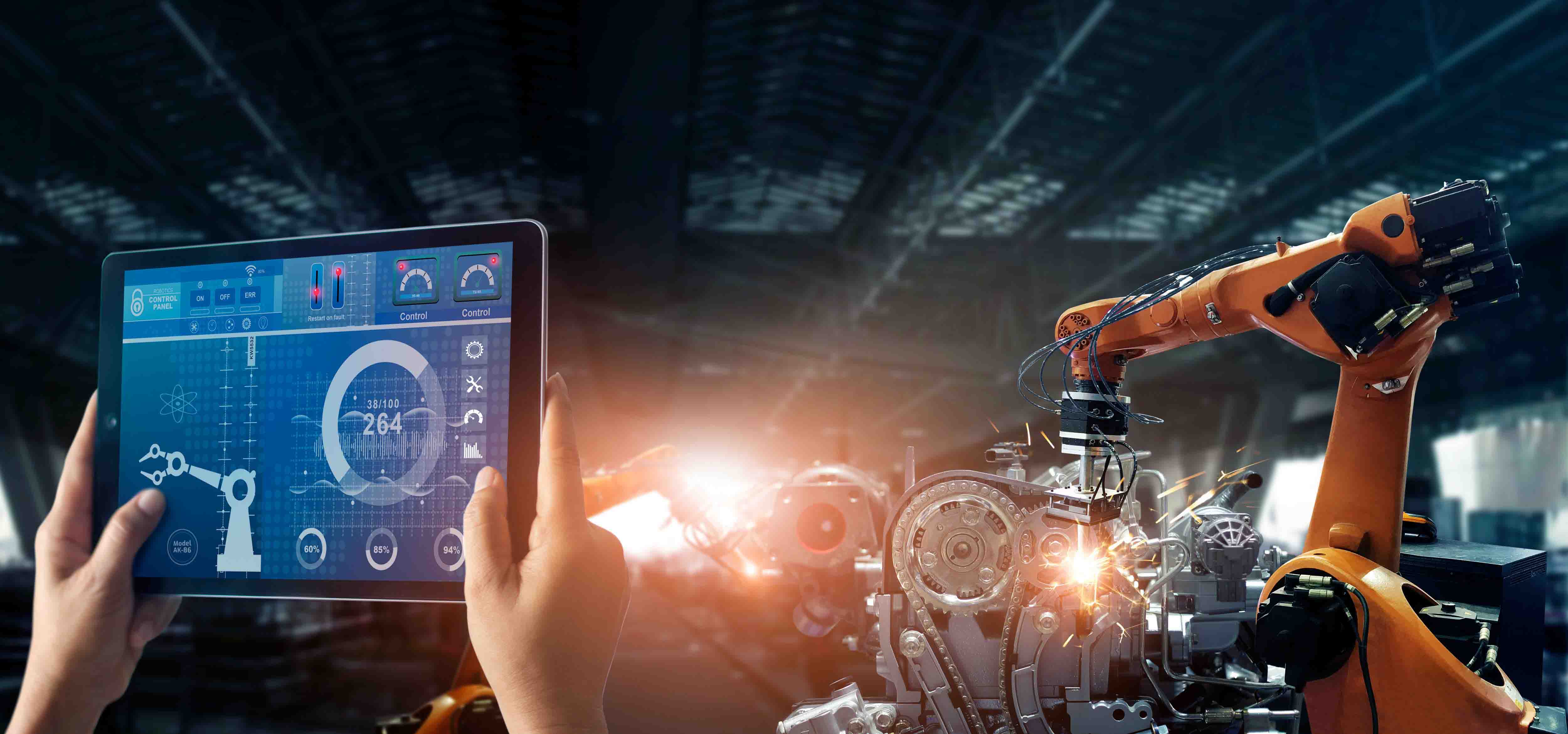 Tablet displaying equipment information beside an industrial robotic production line.