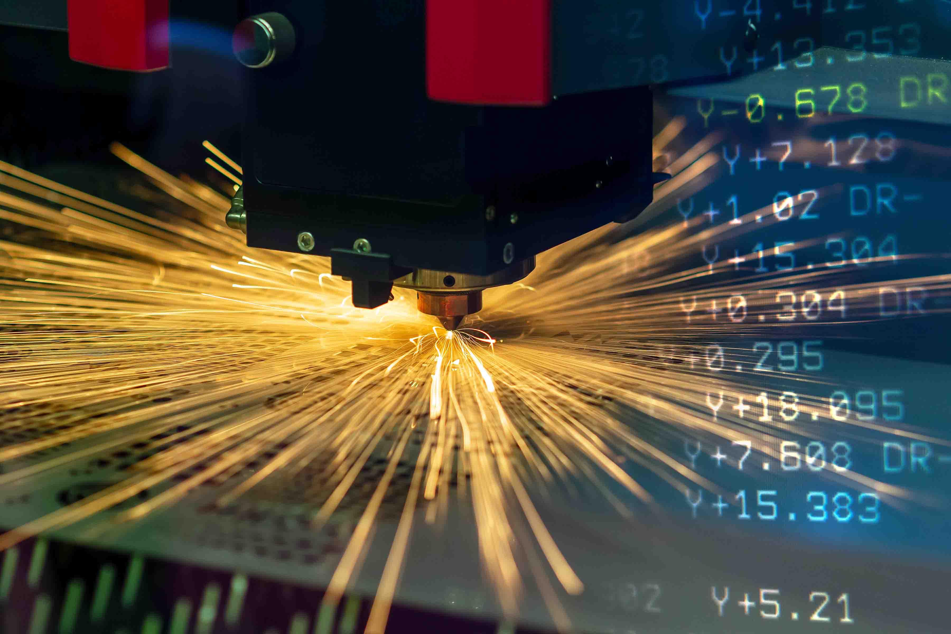 Laser cutting metal with an overlay of numerical control code.